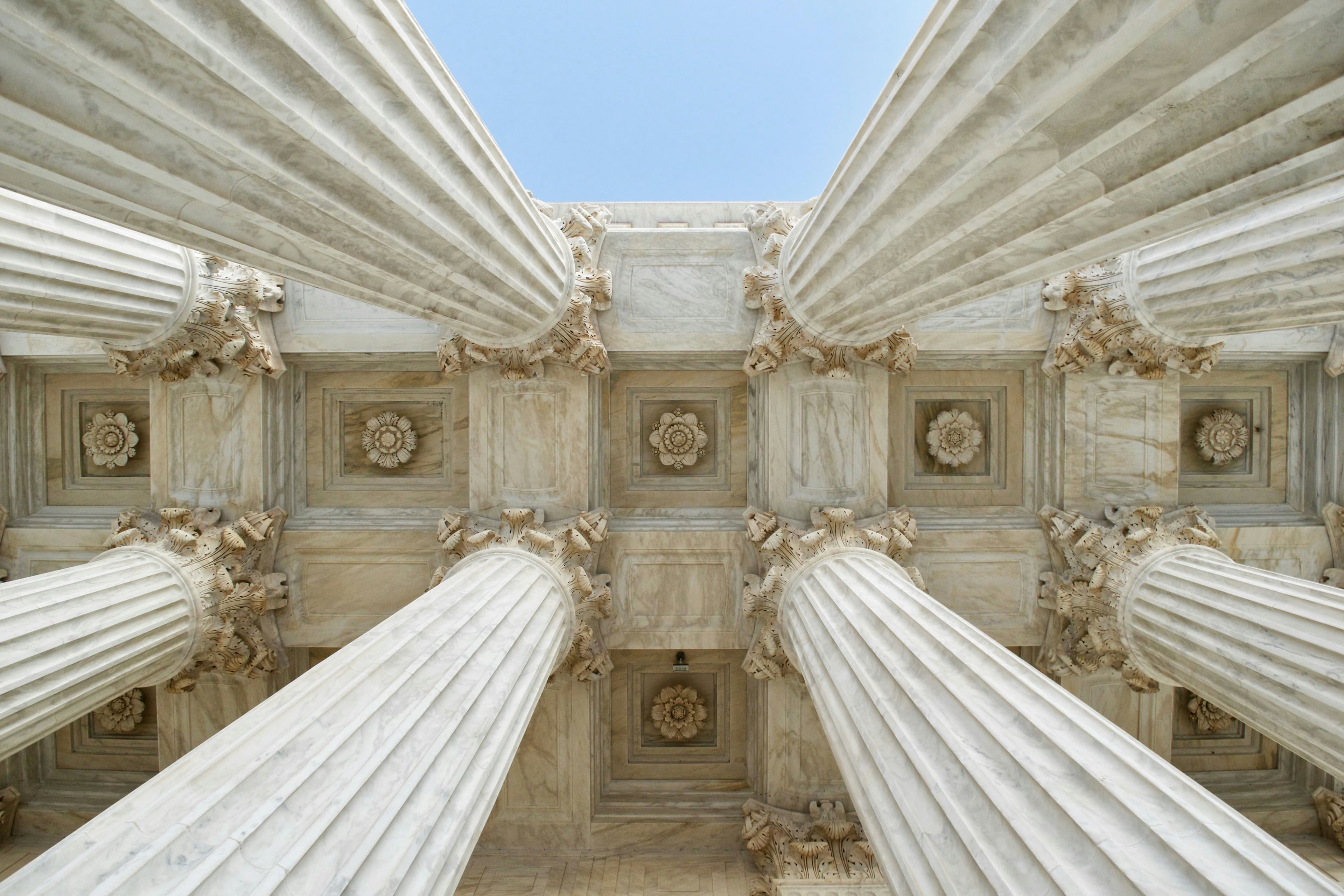 Neoclassical marble columns and coffered ceiling of a courthouse