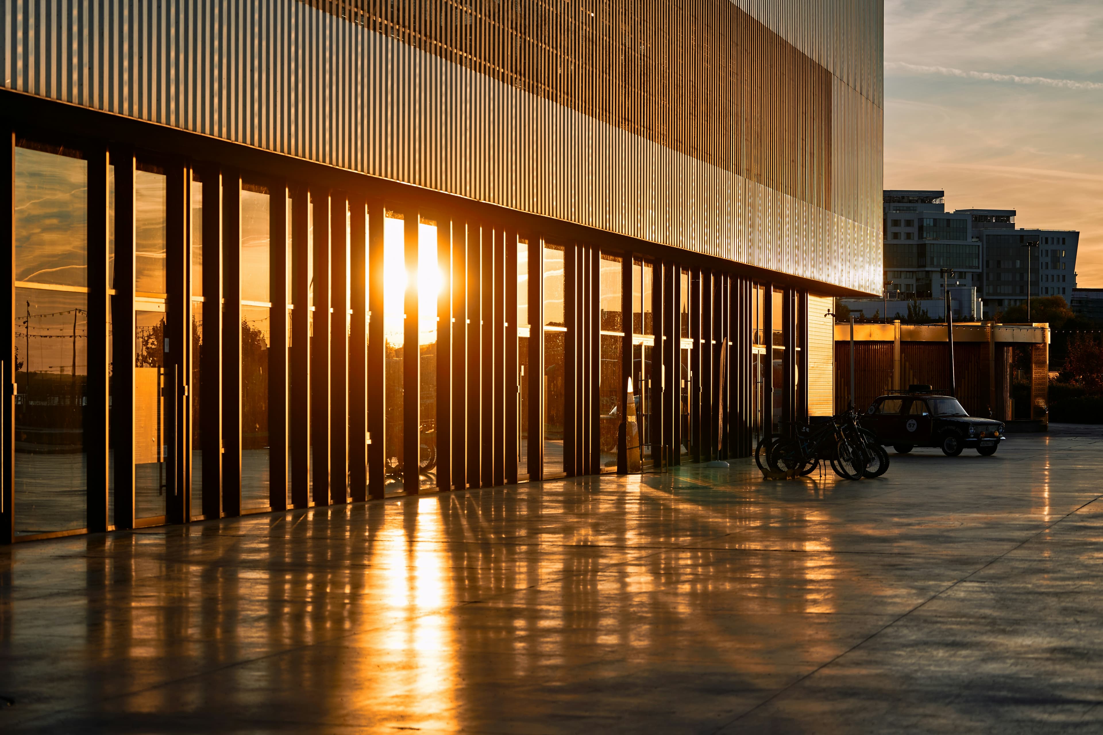 Modern architectural colonnade reflected at golden-hour sunset