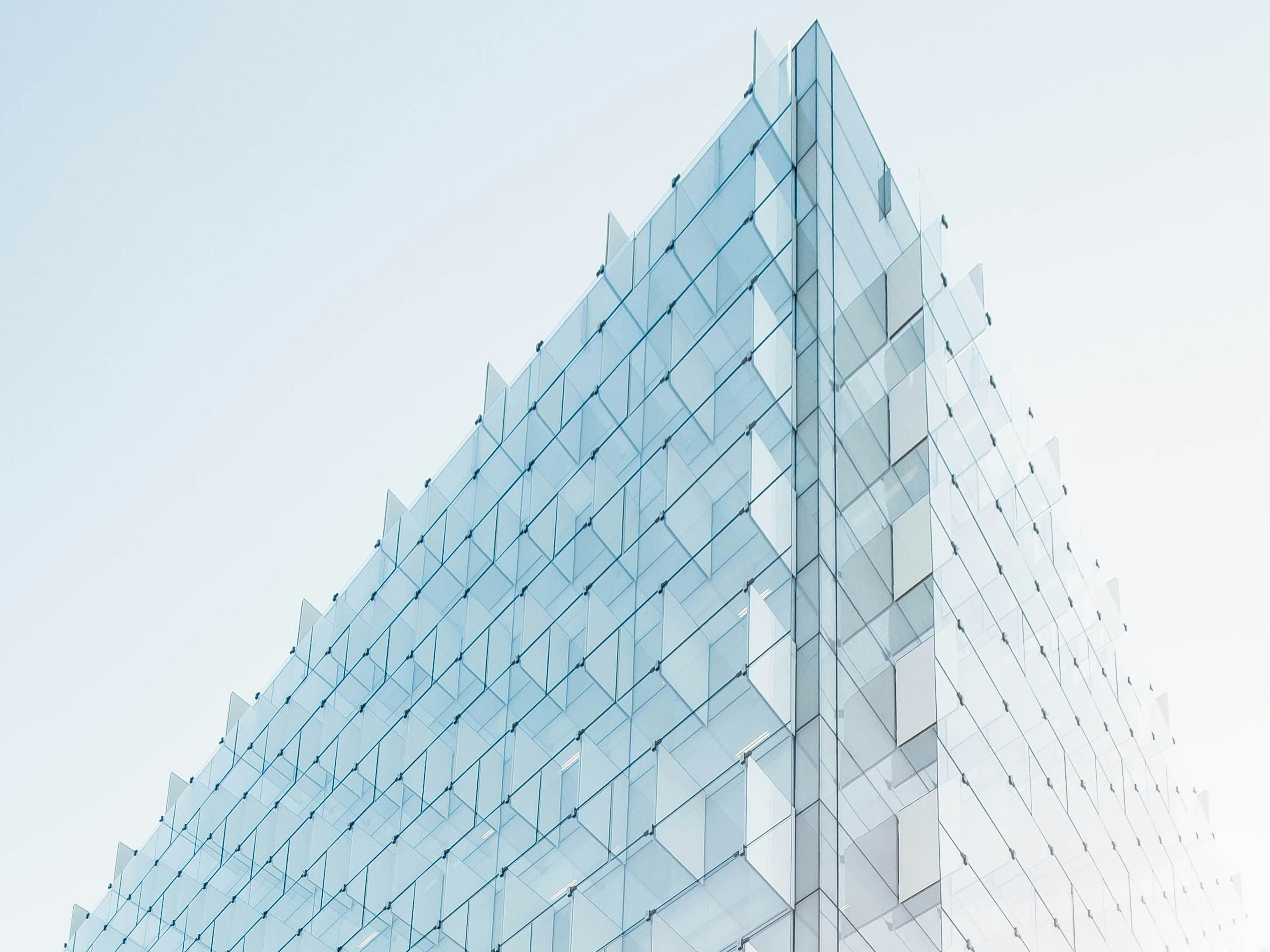 Contemporary glass office building against a clear sky